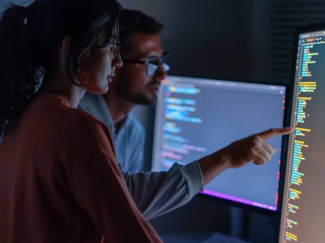Computer, Female programmer and male training for coding, cyber security or software on computer. Female IT specialist, male coder or talking to connect internet, information update and cloud computing . coding development concept.