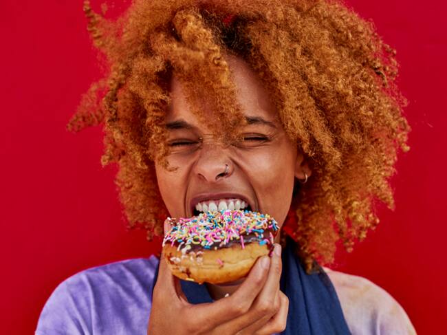 Portrait of woman eating a donut