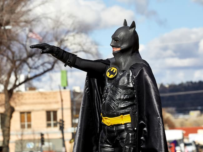 Prescott, Arizona, USA - December 1, 2018: Man wearing a batman costume waving while marching in the Christmas parade in downtown Prescott