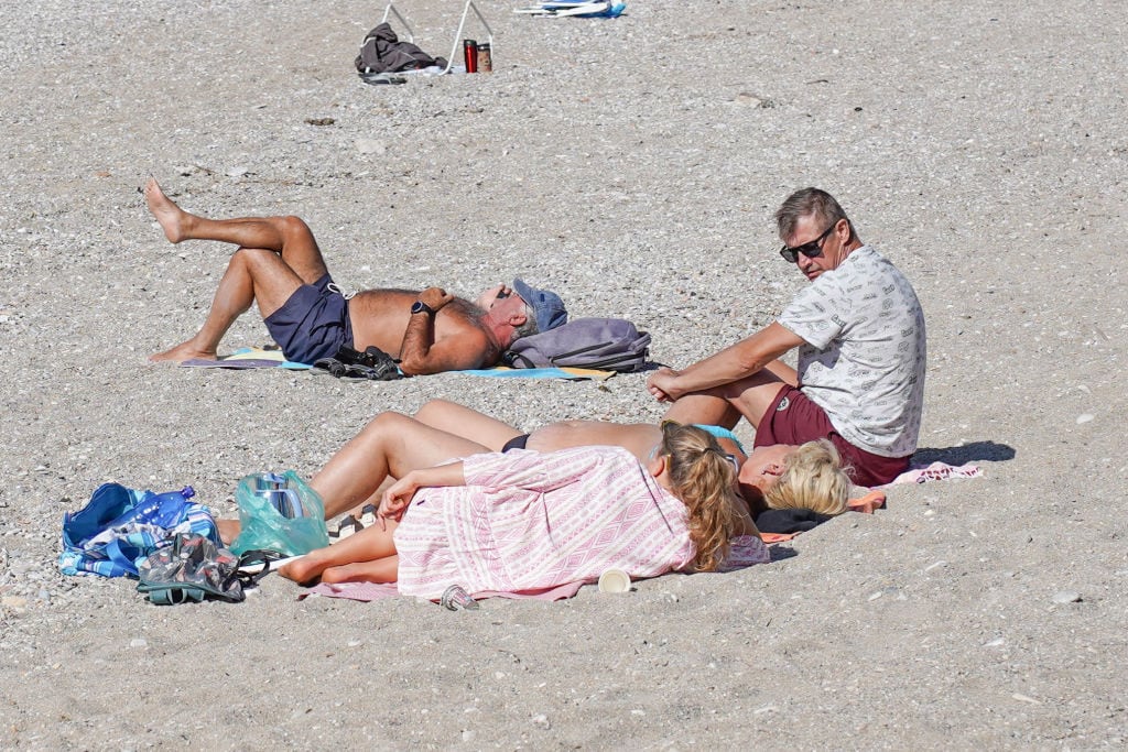 People enjoy the warm weather in Athens, Greece, on October 18, 2024. (Photo by Giannis Alexopoulos/NurPhoto via Getty Images)